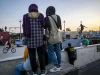 Iranian youths watch a participant perform in a freestyle bicycle competition at the Navid BMX Bike Park in southern Tehran, Iran, on Octobe...