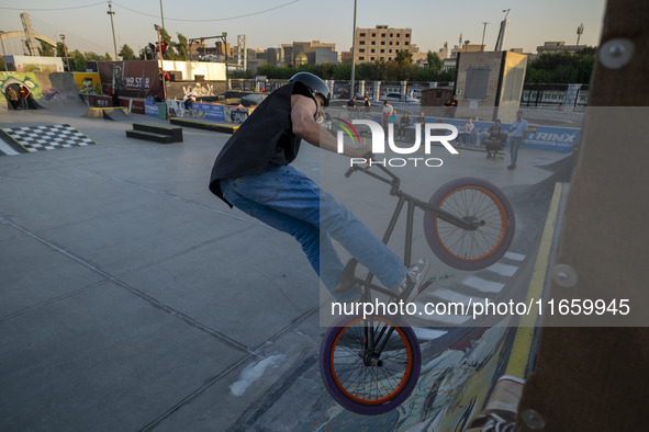 An Iranian participant performs in a freestyle bicycle competition at the Navid BMX Bike Park in southern Tehran, Iran, on October 11, 2024....