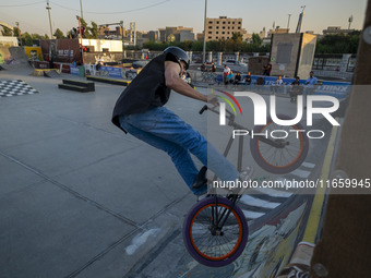 An Iranian participant performs in a freestyle bicycle competition at the Navid BMX Bike Park in southern Tehran, Iran, on October 11, 2024....