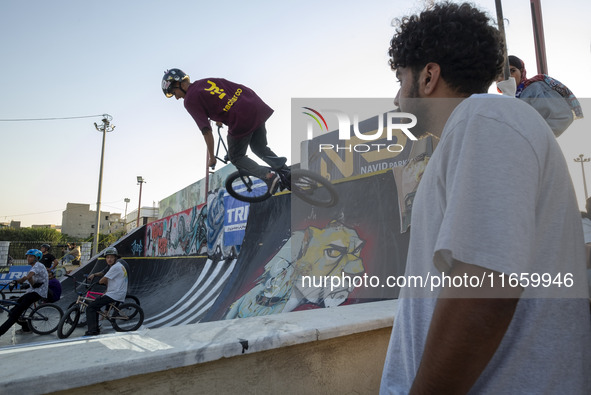 An Iranian participant performs in a freestyle bicycle competition at the Navid BMX Bike Park in southern Tehran, Iran, on October 11, 2024....