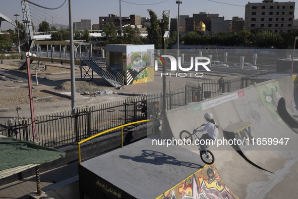 A young Iranian woman performs in a freestyle bicycle competition at the Navid BMX Bike Park in southern Tehran, Iran, on October 11, 2024. 