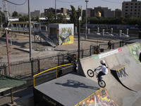 A young Iranian woman performs in a freestyle bicycle competition at the Navid BMX Bike Park in southern Tehran, Iran, on October 11, 2024....