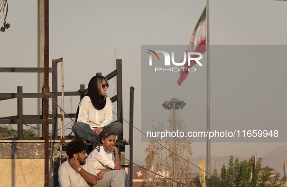 Iranian youths watch a freestyle bicycle competition at the Navid BMX Bike Park in southern Tehran, Iran, on October 11, 2024. 