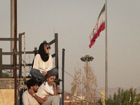 Iranian youths watch a freestyle bicycle competition at the Navid BMX Bike Park in southern Tehran, Iran, on October 11, 2024. (