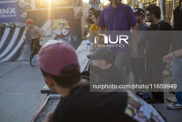 Iranian youths watch a freestyle bicycle competition at the Navid BMX Bike Park in southern Tehran, Iran, on October 11, 2024. 