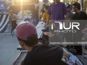 Iranian youths watch a freestyle bicycle competition at the Navid BMX Bike Park in southern Tehran, Iran, on October 11, 2024. (