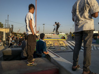 Iranian youths watch a participant perform in a freestyle bicycle competition at the Navid BMX Bike Park in southern Tehran, Iran, on Octobe...