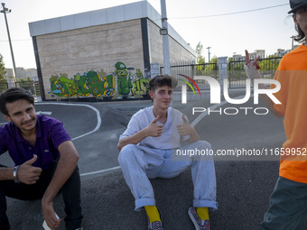 Iranian participants (R) and (C) react while waiting to perform in a freestyle bicycle competition at the Navid BMX Bike Park in southern Te...