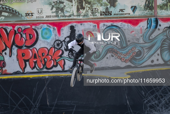 A young Iranian woman performs in a freestyle bicycle competition at the Navid BMX Bike Park in southern Tehran, Iran, on October 11, 2024. 