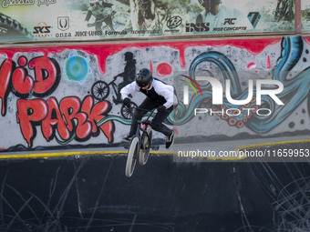 A young Iranian woman performs in a freestyle bicycle competition at the Navid BMX Bike Park in southern Tehran, Iran, on October 11, 2024....