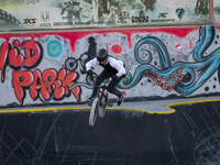 A young Iranian woman performs in a freestyle bicycle competition at the Navid BMX Bike Park in southern Tehran, Iran, on October 11, 2024....