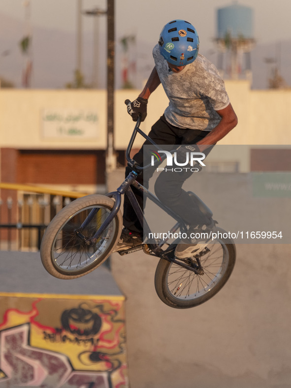 An Iranian participant performs in a freestyle bicycle competition at the Navid BMX Bike Park in southern Tehran, Iran, on October 11, 2024....