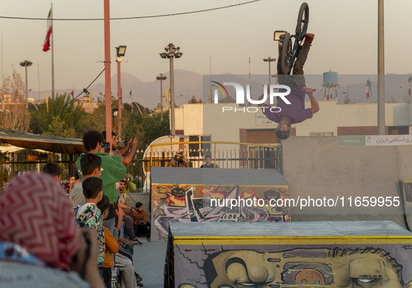 An Iranian participant performs in a freestyle bicycle competition at the Navid BMX Bike Park in southern Tehran, Iran, on October 11, 2024....