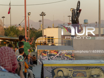 An Iranian participant performs in a freestyle bicycle competition at the Navid BMX Bike Park in southern Tehran, Iran, on October 11, 2024....