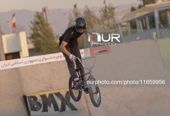 An Iranian participant performs in a freestyle bicycle competition at the Navid BMX Bike Park in southern Tehran, Iran, on October 11, 2024....