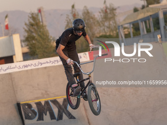 An Iranian participant performs in a freestyle bicycle competition at the Navid BMX Bike Park in southern Tehran, Iran, on October 11, 2024....