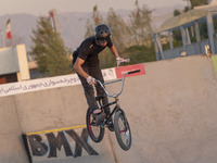 An Iranian participant performs in a freestyle bicycle competition at the Navid BMX Bike Park in southern Tehran, Iran, on October 11, 2024....