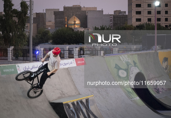 An Iranian participant performs in a freestyle bicycle competition at the Navid BMX Bike Park in southern Tehran, Iran, on October 11, 2024....