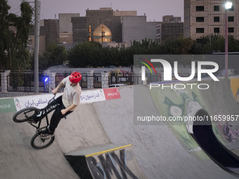 An Iranian participant performs in a freestyle bicycle competition at the Navid BMX Bike Park in southern Tehran, Iran, on October 11, 2024....