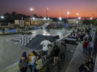 Iranian youths watch a participant perform in a freestyle bicycle competition at the Navid BMX Bike Park in southern Tehran, Iran, on Octobe...