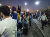 An Iranian policeman monitors an area while youths watch a freestyle bicycle competition at the Navid BMX Bike Park in southern Tehran, Iran...