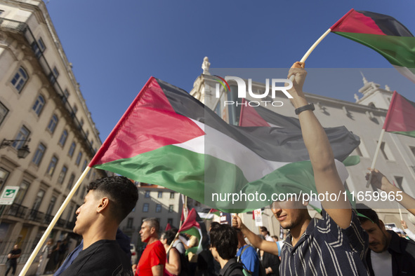 A person holds a Palestinian flag during a demonstration supporting Palestine in Lisbon, Portugal, on October 12, 2024. 