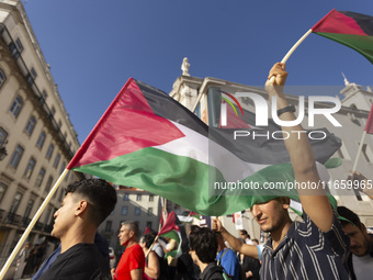 A person holds a Palestinian flag during a demonstration supporting Palestine in Lisbon, Portugal, on October 12, 2024. (