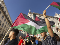 A person holds a Palestinian flag during a demonstration supporting Palestine in Lisbon, Portugal, on October 12, 2024. (