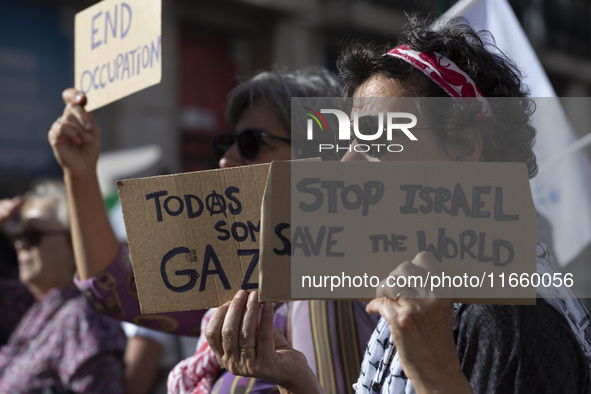 A person holds a banner during a demonstration supporting Palestine in Lisbon, Portugal, on October 12, 2024. 