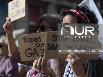 A person holds a banner during a demonstration supporting Palestine in Lisbon, Portugal, on October 12, 2024. (