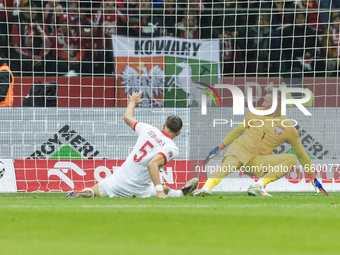 Jan Bednarek  scores an own goal, Lukasz Skorupski  during UEFA Nations League match Poland vs Portugal in Warsaw Poland on 12 October 2024....