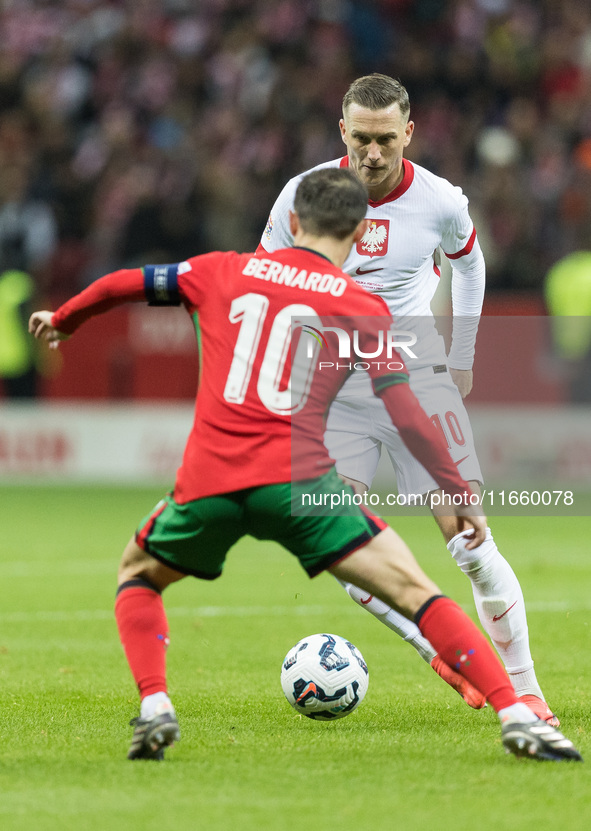 Bernardo Silva , Piotr Zielinski  during UEFA Nations League match Poland vs Portugal in Warsaw Poland on 12 October 2024. 