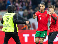 A pitch invader takes a selfie photograph with Portugal forward Cristiano Ronaldo during the  UEFA Nations League 2024 League A Group A1 mat...