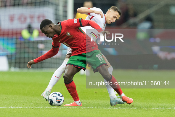 Nuno Mendes , Przemyslaw Frankowski  during UEFA Nations League match Poland vs Portugal in Warsaw Poland on 12 October 2024. 