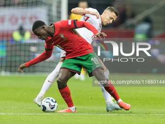 Nuno Mendes , Przemyslaw Frankowski  during UEFA Nations League match Poland vs Portugal in Warsaw Poland on 12 October 2024. (