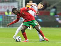 Nuno Mendes , Przemyslaw Frankowski  during UEFA Nations League match Poland vs Portugal in Warsaw Poland on 12 October 2024. (