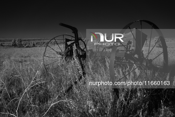 An abandoned seed spreader sits rusting on the plains of Fall River, South Dakota, USA. 