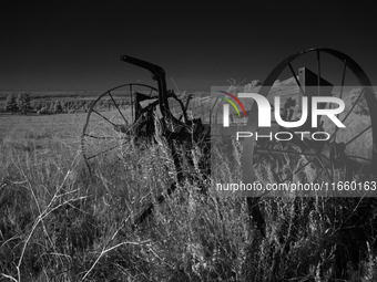 An abandoned seed spreader sits rusting on the plains of Fall River, South Dakota, USA. (