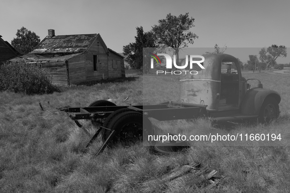 An abandoned pickup truck sits in front of an abandoned farm in the ghost town of Owanka, South Dakota, USA. 