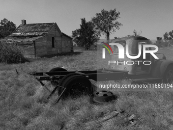 An abandoned pickup truck sits in front of an abandoned farm in the ghost town of Owanka, South Dakota, USA. (