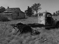 An abandoned pickup truck sits in front of an abandoned farm in the ghost town of Owanka, South Dakota, USA. (