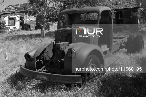 An abandoned pickup truck sits in front of an abandoned farm in the ghost town of Owanka, South Dakota, USA. 