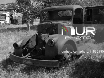 An abandoned pickup truck sits in front of an abandoned farm in the ghost town of Owanka, South Dakota, USA. (