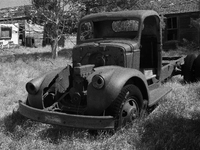 An abandoned pickup truck sits in front of an abandoned farm in the ghost town of Owanka, South Dakota, USA. (