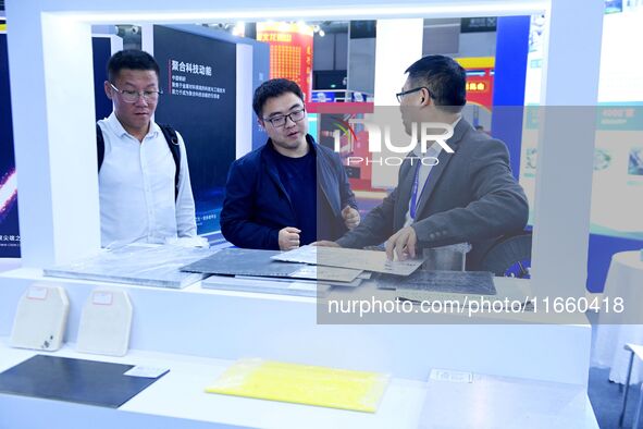 Visitors communicate with exhibitors at the 9th China Advanced Materials Industry Expo 2024 in Qingdao, China, on October 12, 2024. 