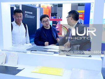 Visitors communicate with exhibitors at the 9th China Advanced Materials Industry Expo 2024 in Qingdao, China, on October 12, 2024. (