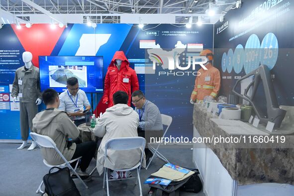 Visitors communicate with exhibitors at the 9th China Advanced Materials Industry Expo 2024 in Qingdao, China, on October 12, 2024. 