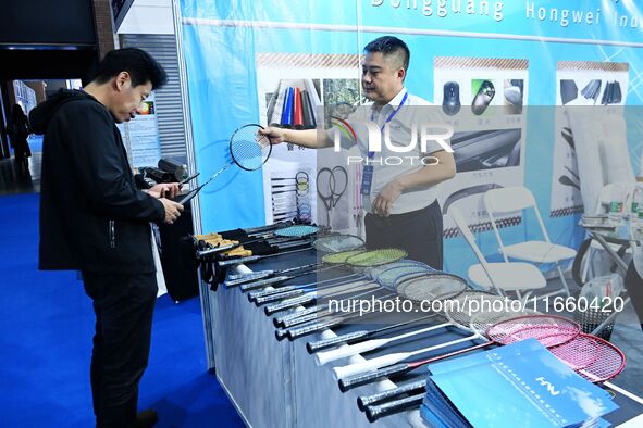 Visitors communicate with exhibitors at the 9th China Advanced Materials Industry Expo 2024 in Qingdao, China, on October 12, 2024. 