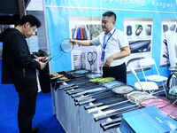 Visitors communicate with exhibitors at the 9th China Advanced Materials Industry Expo 2024 in Qingdao, China, on October 12, 2024. (