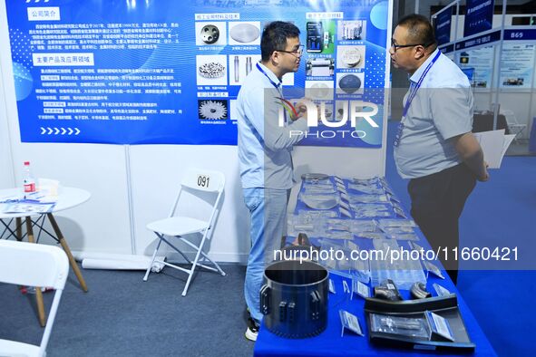 Visitors communicate with exhibitors at the 9th China Advanced Materials Industry Expo 2024 in Qingdao, China, on October 12, 2024. 